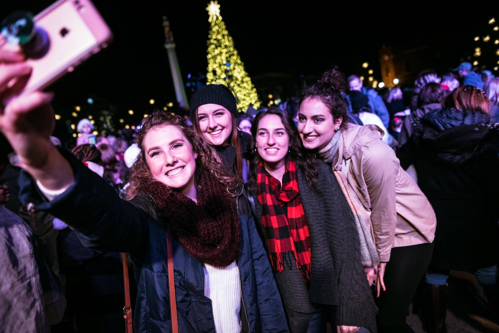 group of four women taking selfie at tree lighting 2017